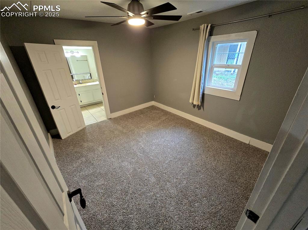Image 7 of 22: Carpeted empty room featuring a ceiling fan and baseboards