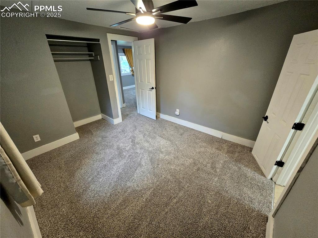 Image 8 of 22: Bedroom with carpet flooring, baseboards, a closet, and ceiling fan