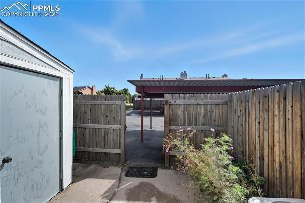 Image 16 of 34: View of fenced backyard