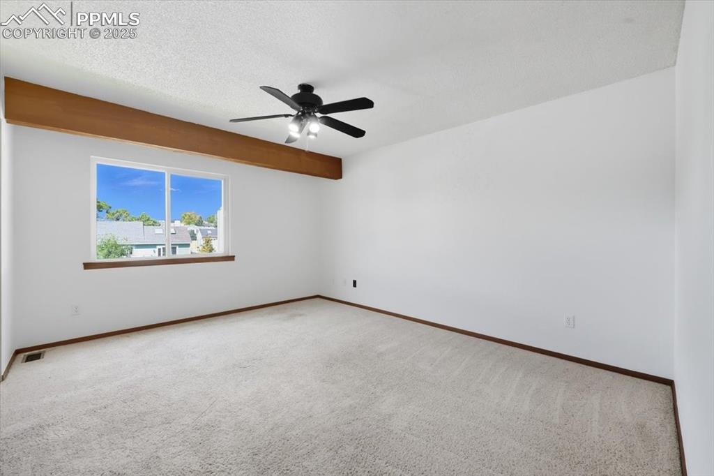 Image 19 of 34: Carpeted empty room featuring a textured ceiling and a ceiling fan
