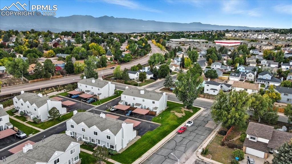 Image 31 of 34: Aerial perspective of suburban area with a mountain backdrop