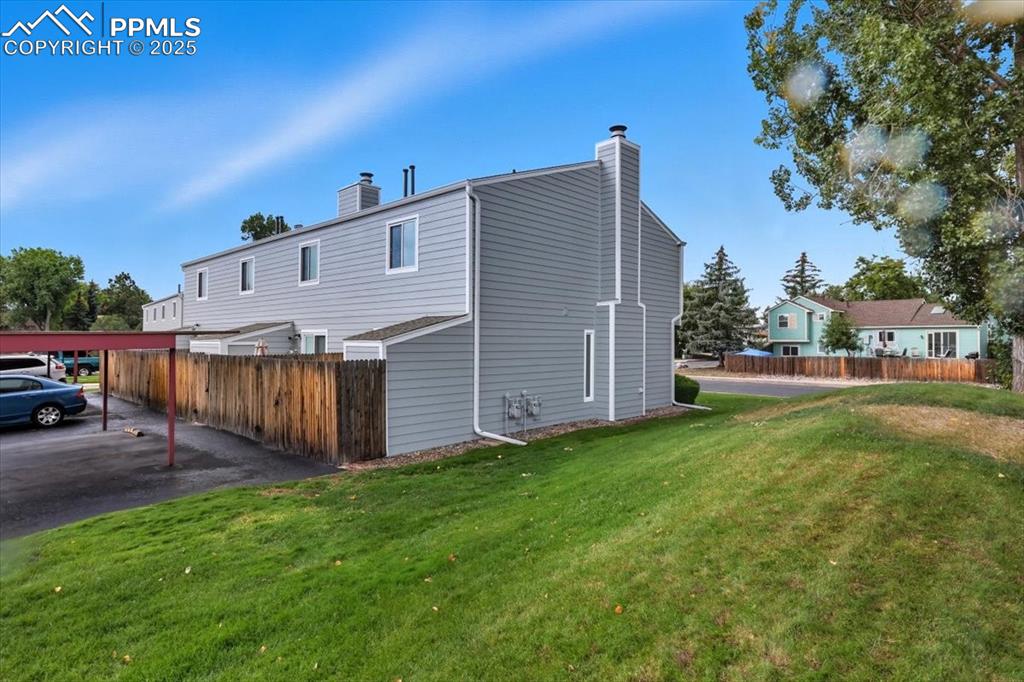 Image 32 of 34: Back of house featuring a chimney