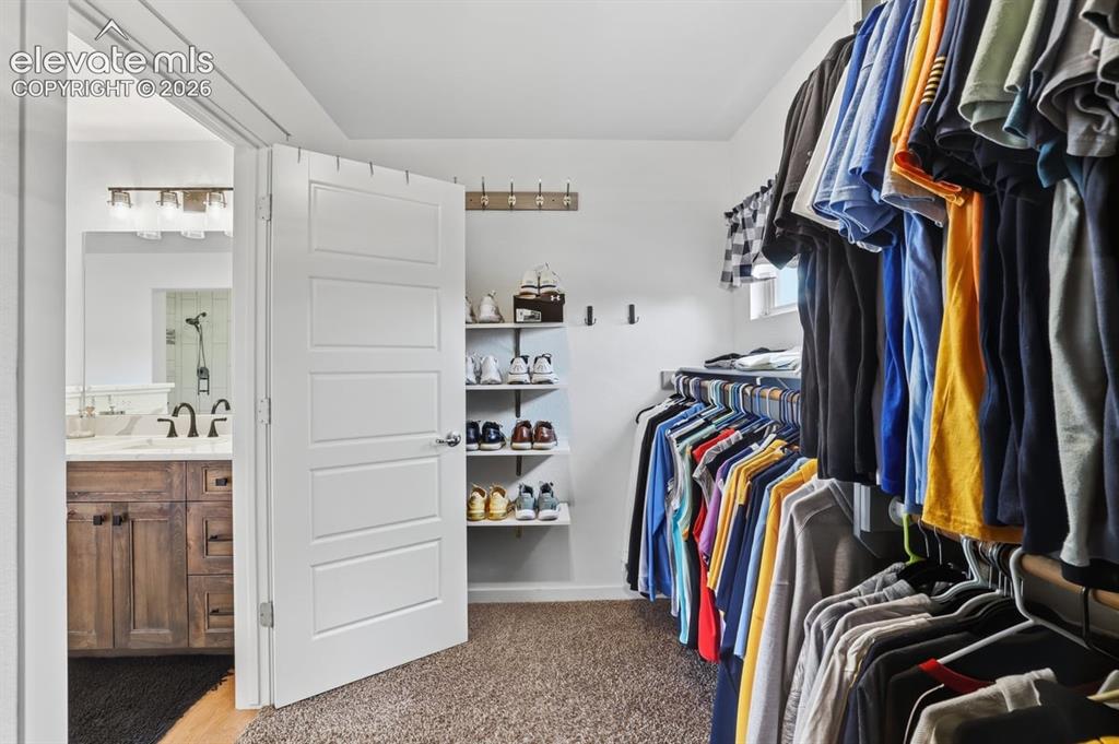 Image 22 of 50: walk-in closet with windows for added light