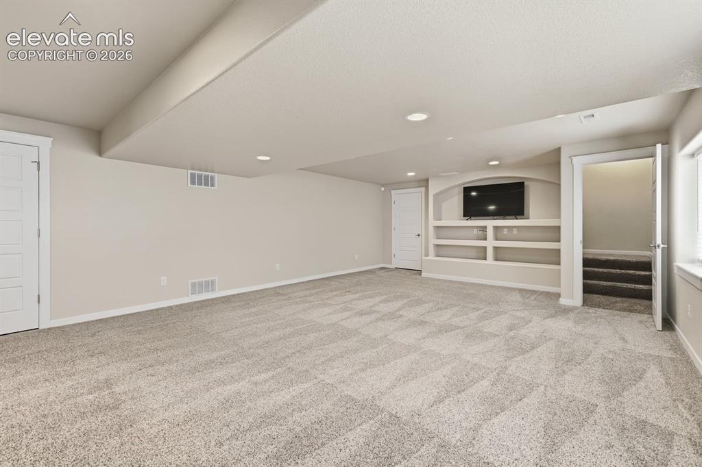 Image 35 of 50: large family room area with custom built-in entertainment center