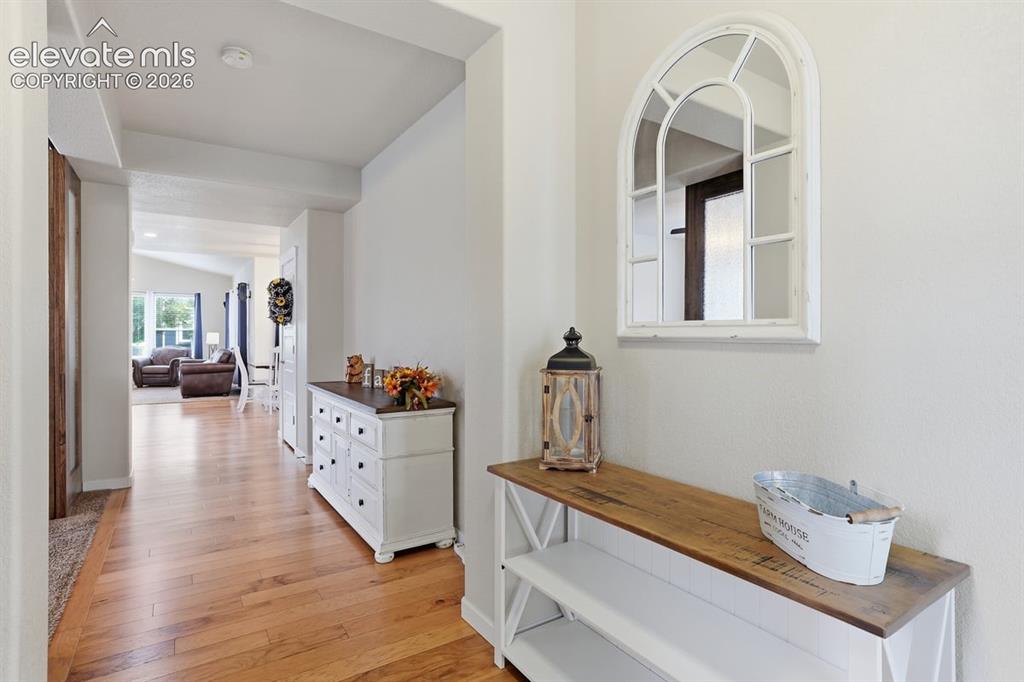 Image 5 of 50: foyer, wood laminate flooring and 9-foot ceilings