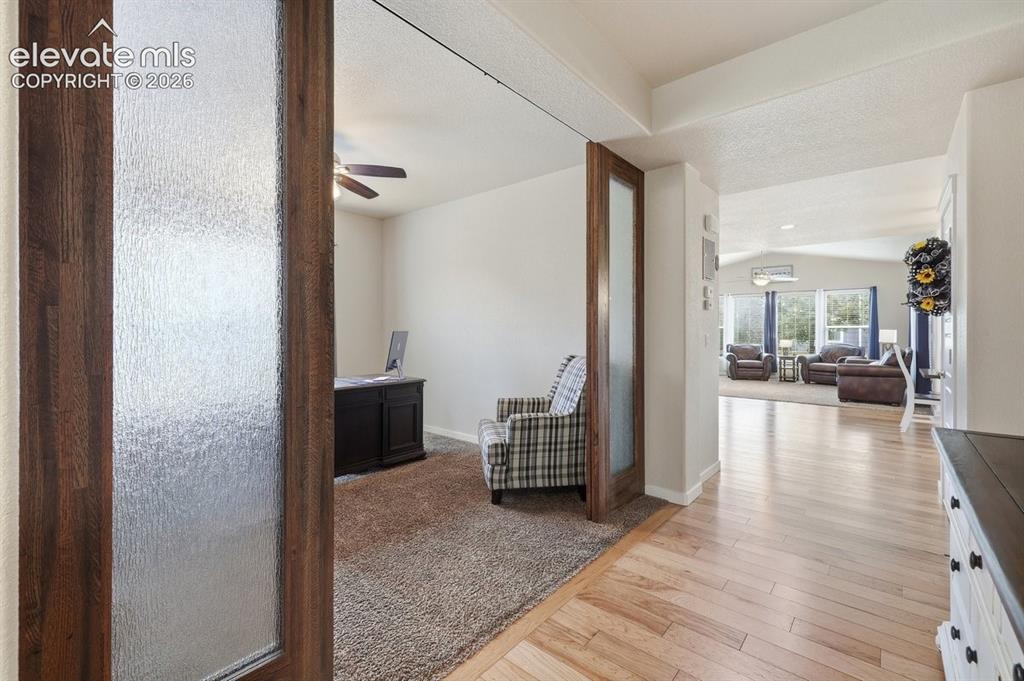 Image 6 of 50: custom barn doors provide privacy for the office space