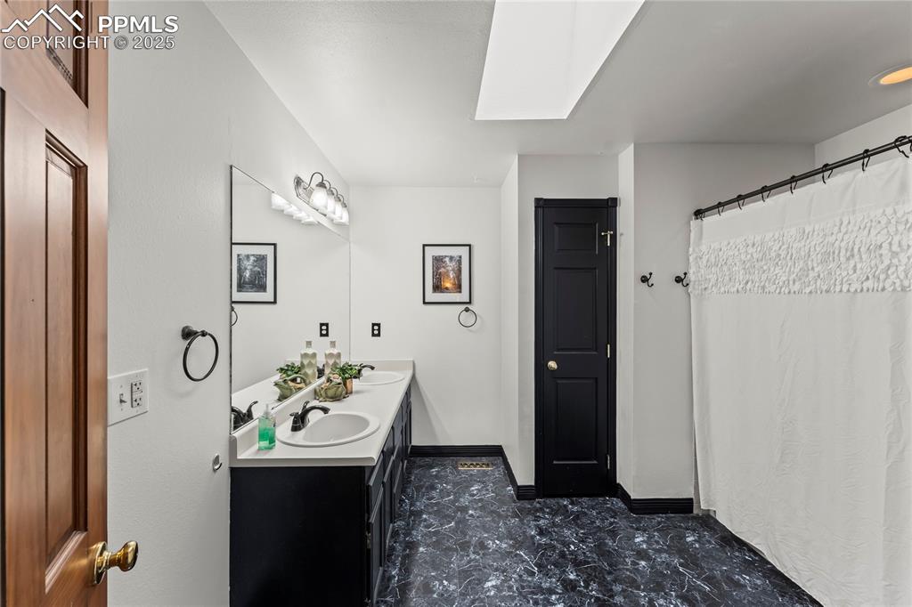 Image 14 of 21: Primary bathroom with double vanity