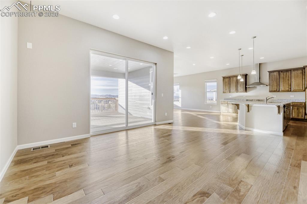 Image 8 of 28: Spacious Dining Room that leads out to huge covered deck!