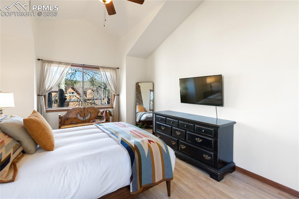 Image 16 of 50: Primary bedroom is lacking nothing with vaulted ceilings, large windows, wo