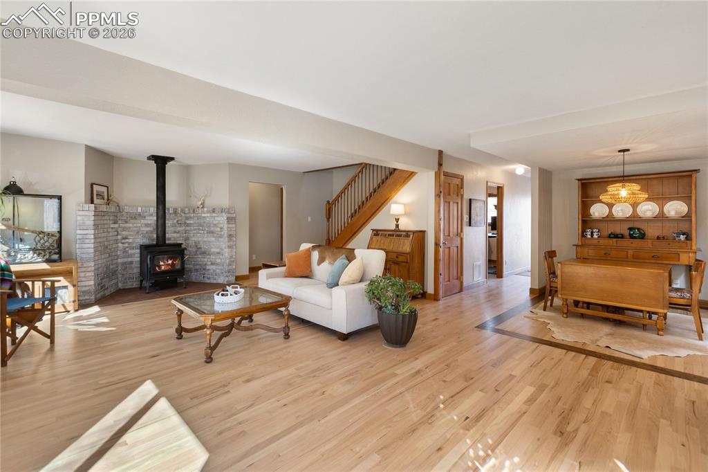 Image 2 of 50: Hard wood floors throughout! Wood Buring fireplace, open concept, natural l