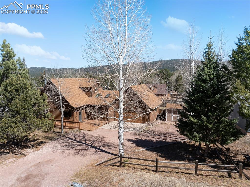 Image 20 of 50: Flat lawn, mature aspen and pine trees