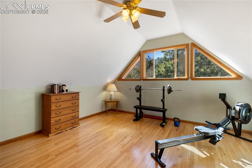 Image 34 of 50: Second level bedroom is large currently used as work out area, vaulted ceil