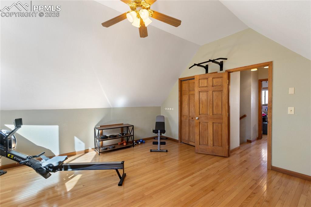 Image 35 of 50: Second level bedroom is large currently used as work out area, vaulted ceil