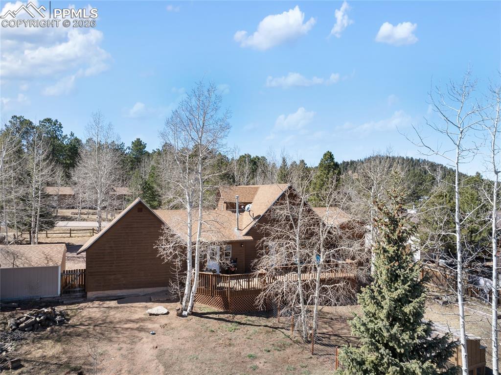 Image 43 of 50: Backyard is large enough for all activities and gatherings, home stands tal