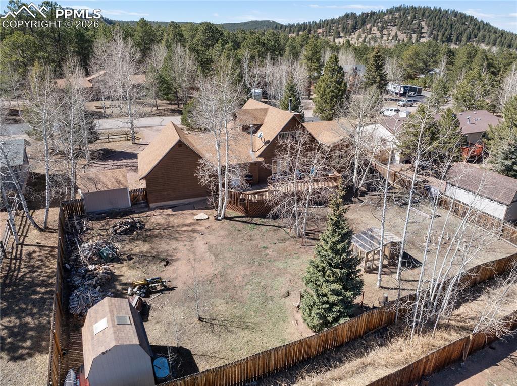 Image 5 of 50: Back yard is fully fenced and set up perfectly with sheds, chicken coop, ga