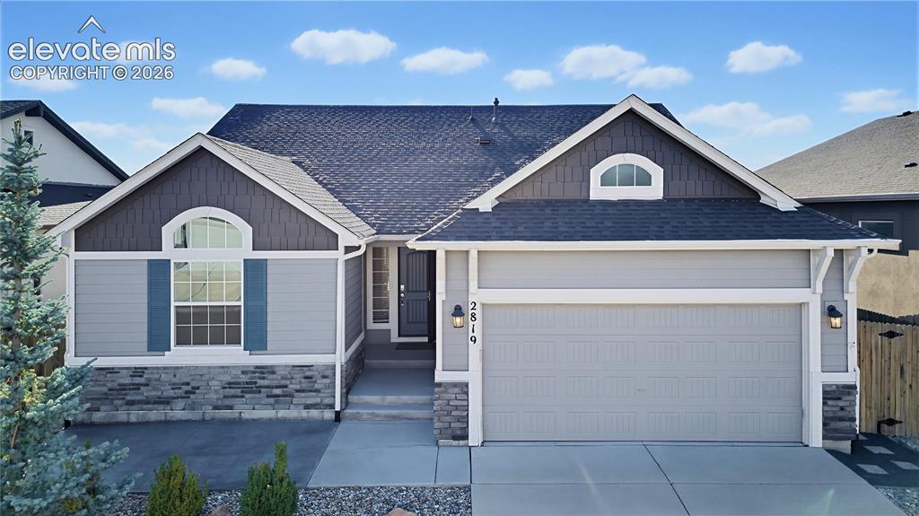 Caption: Multi-gabled exterior featuring a blend of horizontal siding, shake-style accents, stone veneer, arc