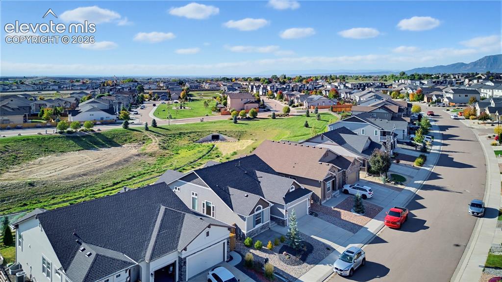 Image 10 of 50: Aerial perspective of a suburban neighborhood featuring multi-level residen