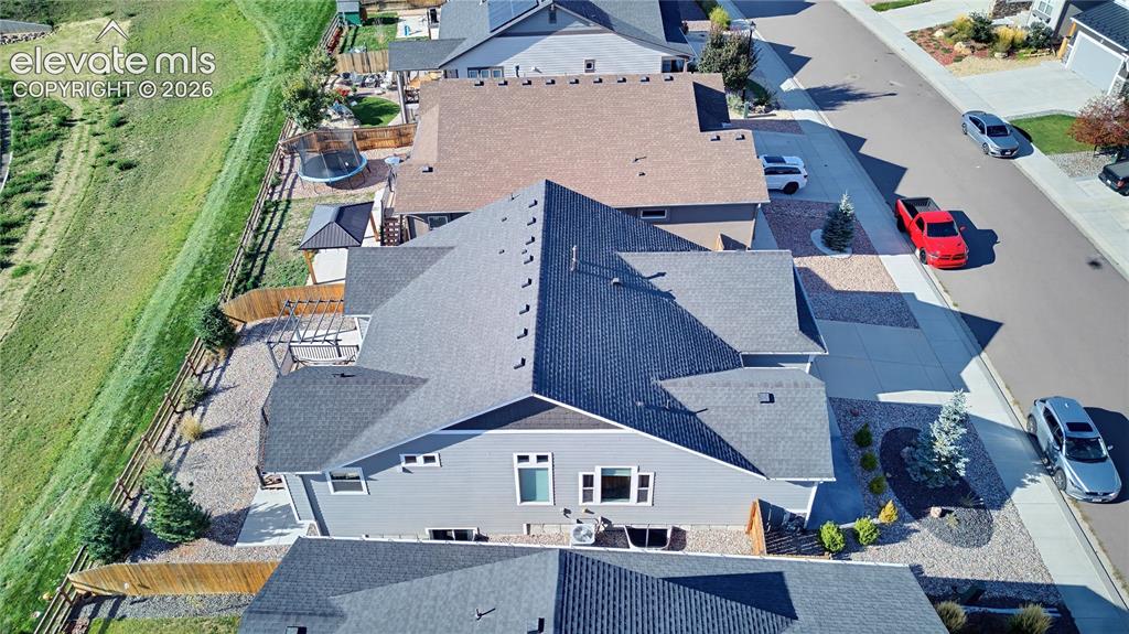 Image 12 of 50: Aerial perspective of a multi-gabled residence featuring horizontal siding,