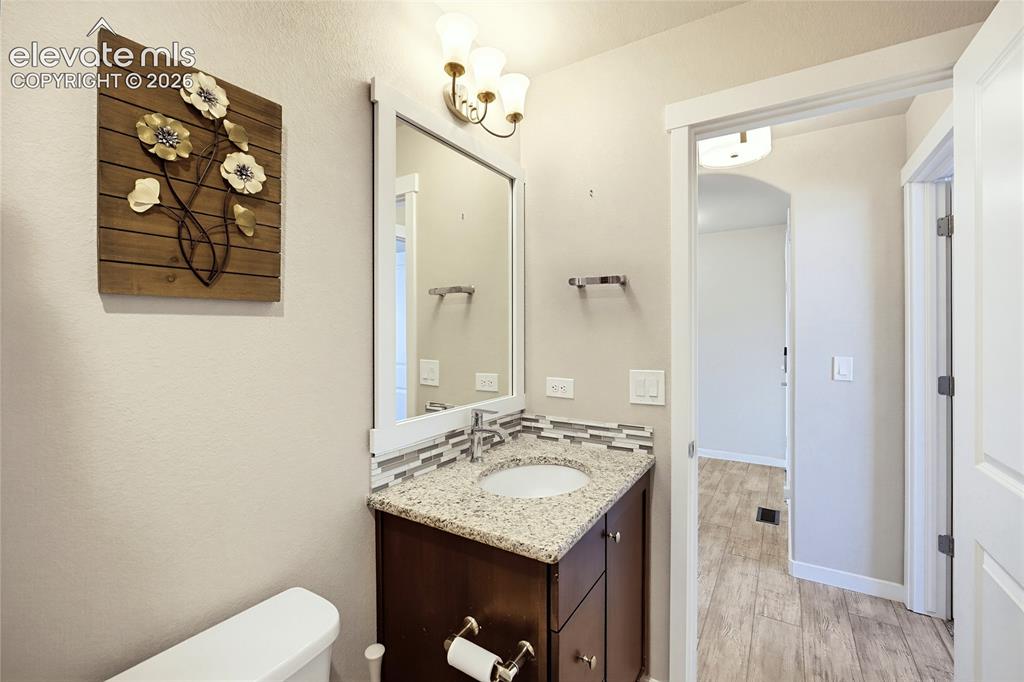 Image 17 of 50: Vanity featuring stone-style countertop, undermount sink, multi-tone mosaic
