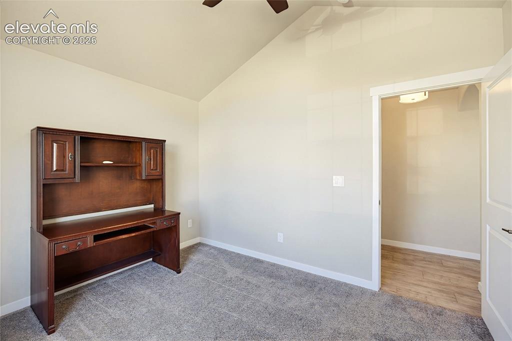 Image 20 of 50: Vaulted ceilings with a ceiling fan, carpeted flooring, and a walk-in close