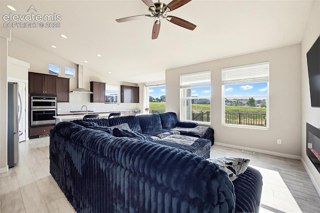 Image 22 of 50: Open-concept floor plan featuring vaulted ceilings, recessed lighting, wood