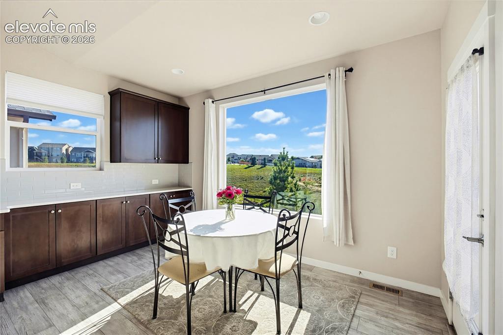 Image 28 of 50: Custom cabinetry with stone-surface countertops, subway tile backsplash, re