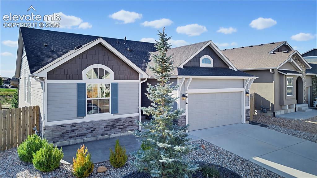 Image 3 of 50: Exterior featuring horizontal lap siding, stone veneer accents, shake-style
