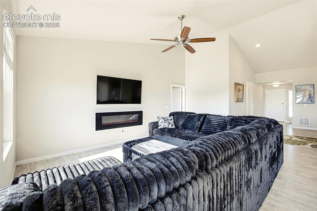 Image 32 of 50: Vaulted ceiling featuring a ceiling fan, recessed lighting, wood-finish flo