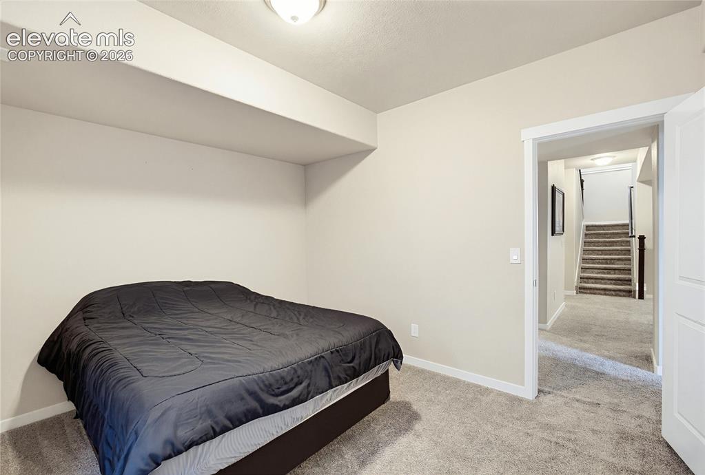 Image 46 of 50: Neutral interior featuring carpeted flooring and a recessed alcove
