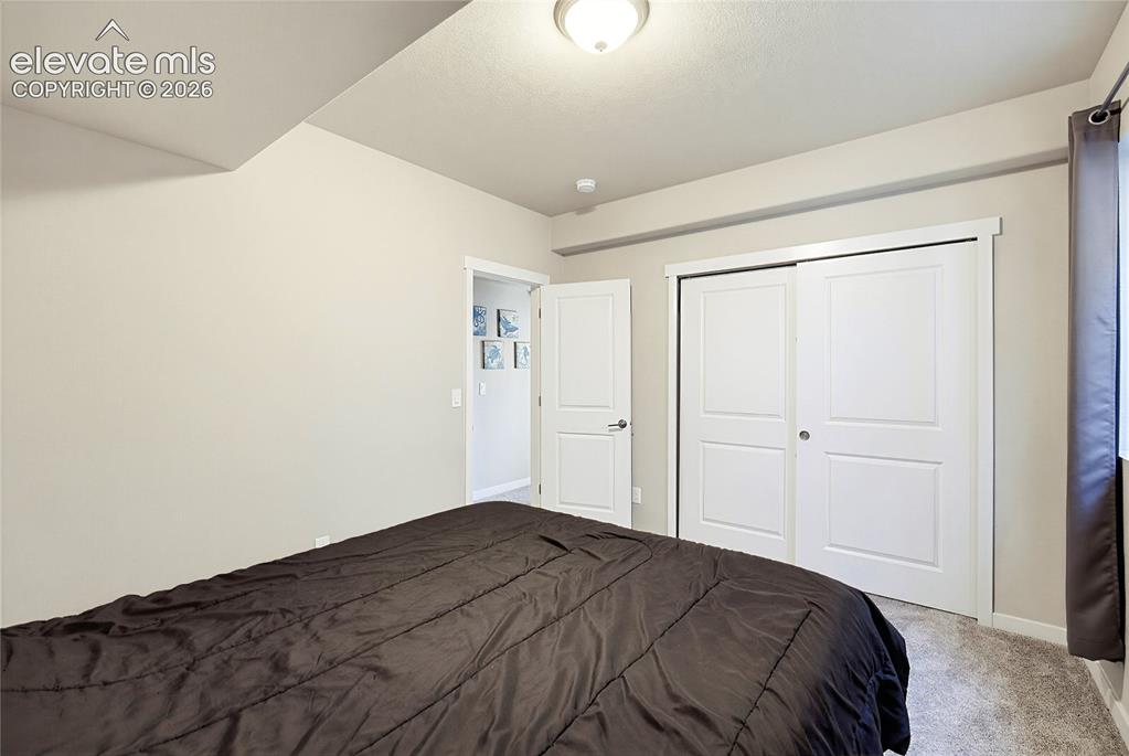 Image 47 of 50: Interior space featuring neutral wall paint, wall-to-wall carpeting, and a 