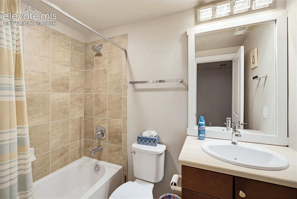 Image 48 of 50: Bathroom featuring a white oval undermount sink, solid-surface countertop,