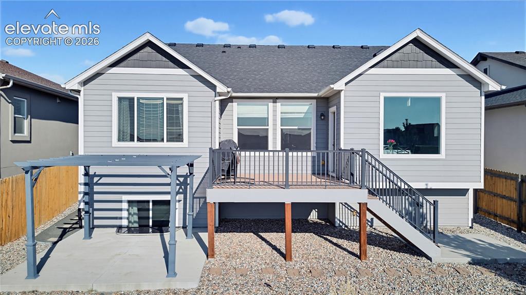 Image 5 of 50: Exterior elevation featuring horizontal siding, a composite shingle roof, a