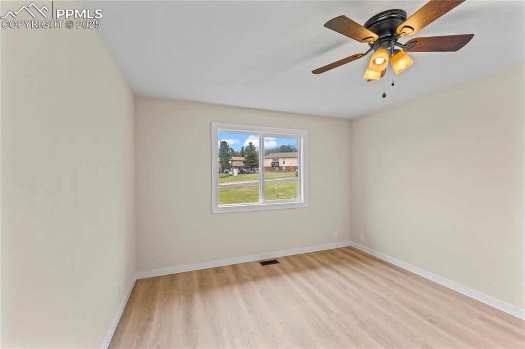 Image 13 of 34: Spare room with light wood-style flooring and a ceiling fan