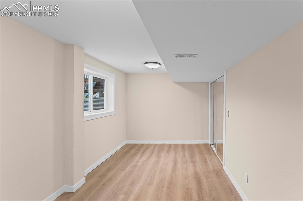 Image 20 of 34: Basement bedroom 1 Below grade area featuring light wood finished floors