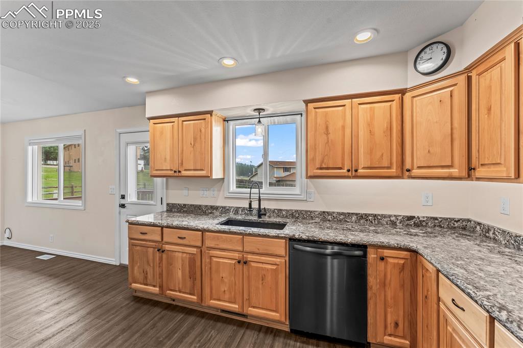 Image 9 of 34: Kitchen featuring dishwasher, dark wood-style flooring, and recessed lighti