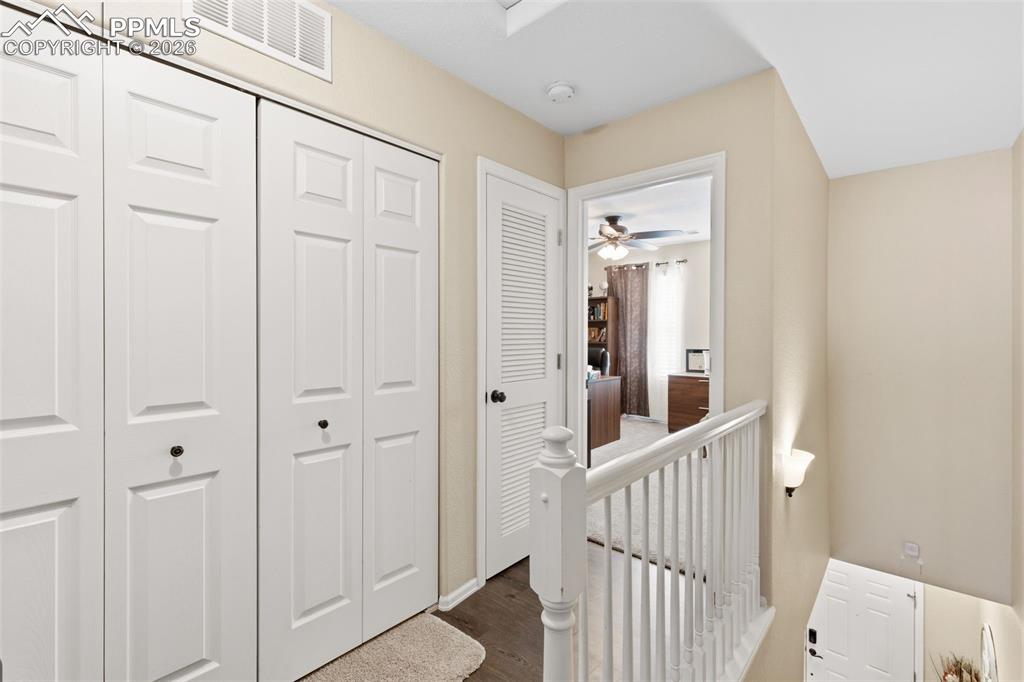 Image 13 of 26: Corridor with dark wood-style flooring