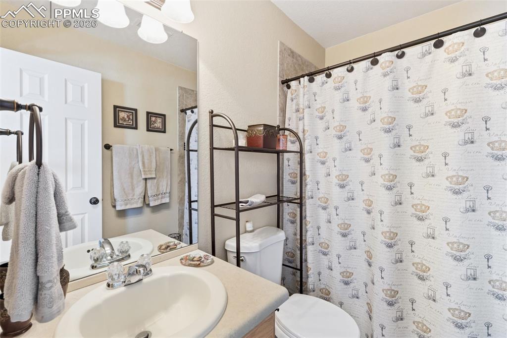 Image 18 of 26: Bathroom with vanity and a shower with curtain