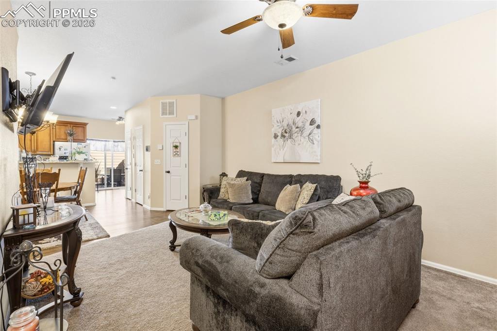 Image 3 of 26: Living room with a ceiling fan and baseboards