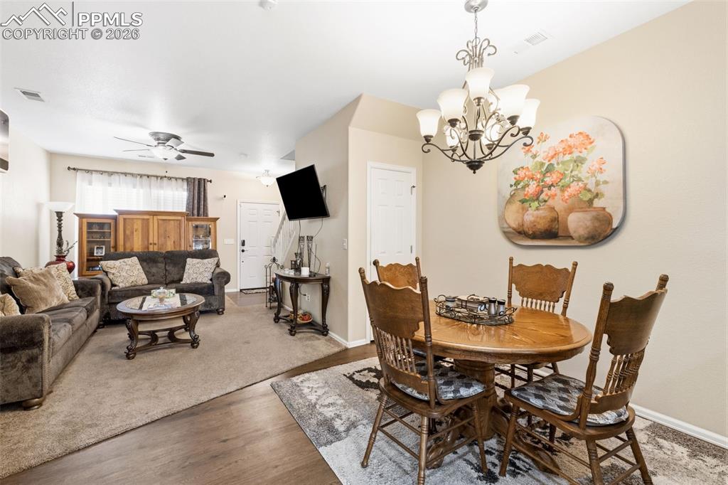 Image 7 of 26: Dining room featuring suspended lighting, wood finished floors, and ceiling