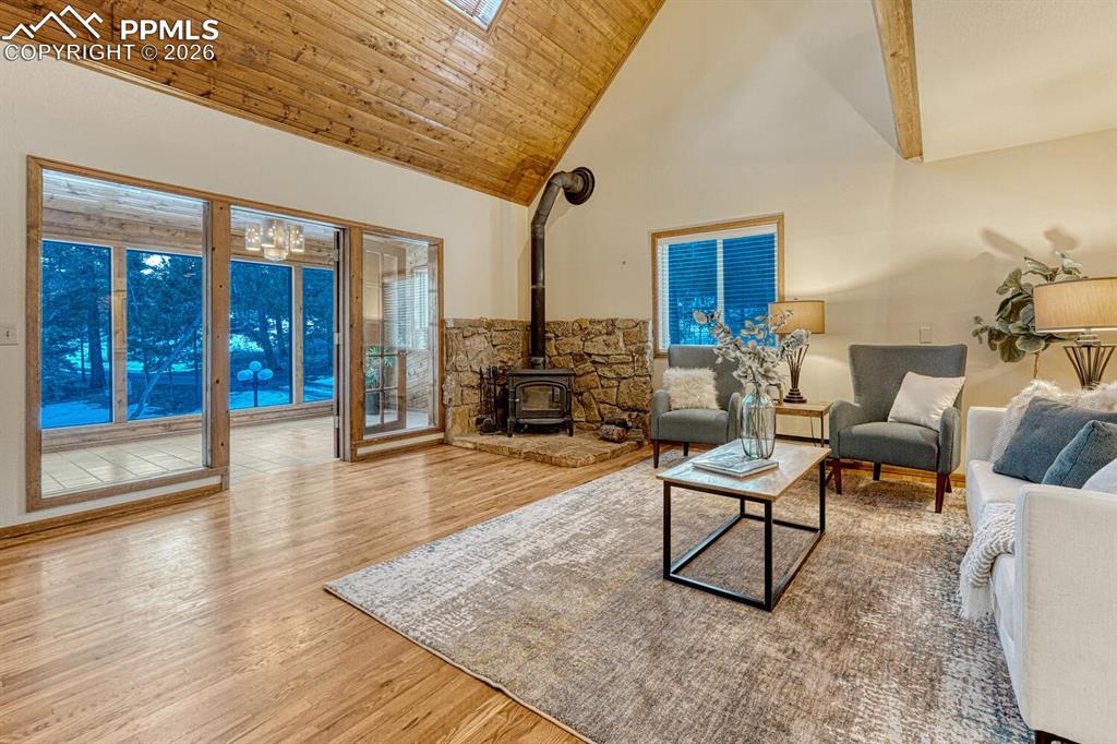 Image 4 of 40: living room looking out to 3 season sunroom