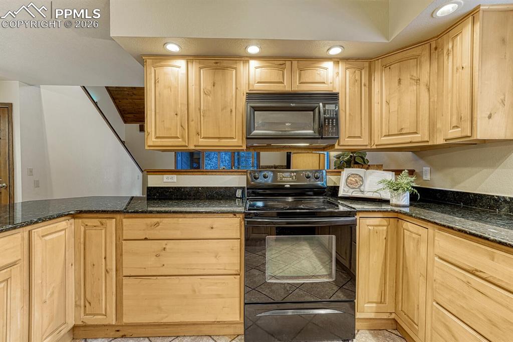 Image 9 of 40: kitchen looking out to living room