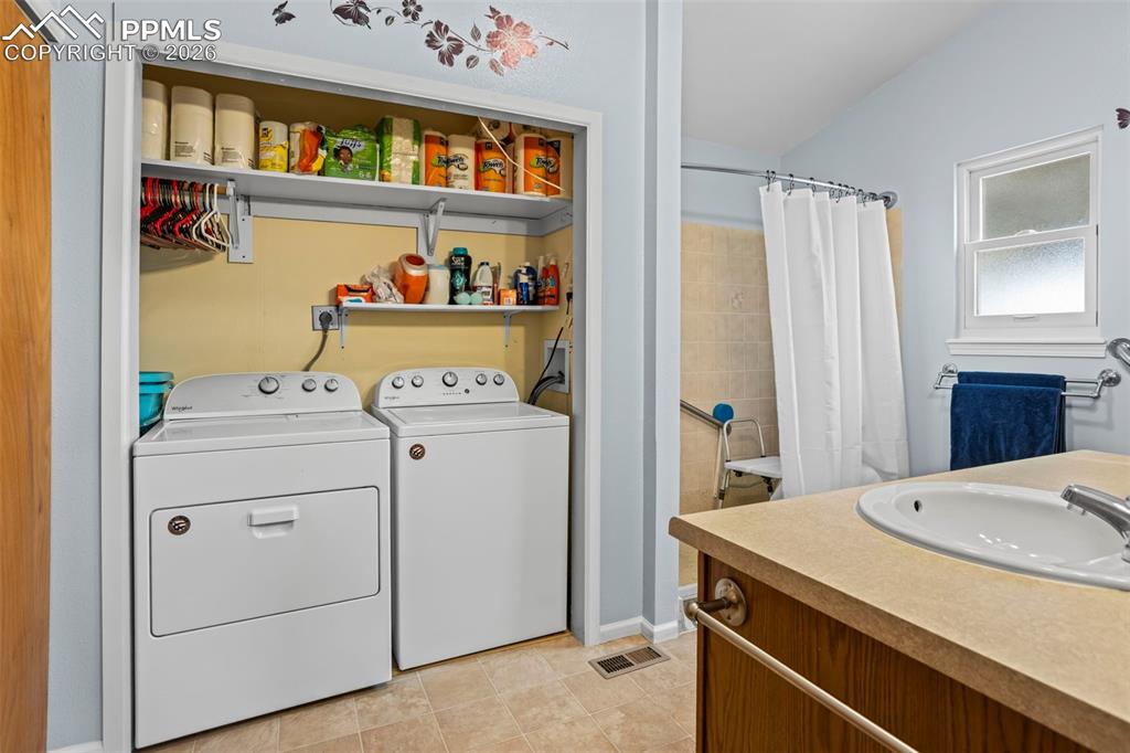 Image 20 of 26: Primary Bathroom - with 2nd laundry space installed - Walk-in shower