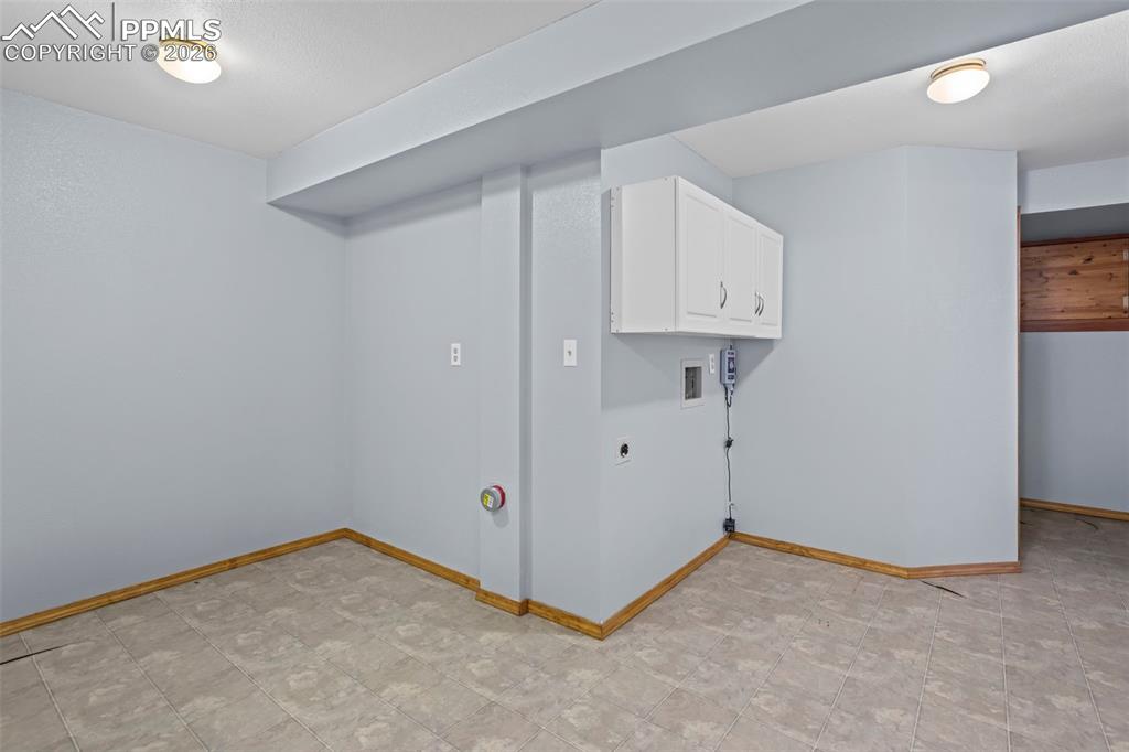 Image 25 of 26: 2nd Laundry space with wall cabinets