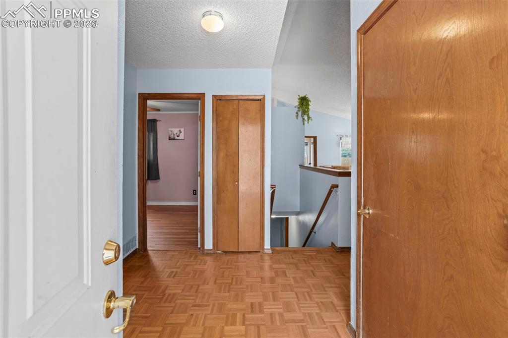 Image 4 of 26: Front entryway with coat closet - stairs to basement