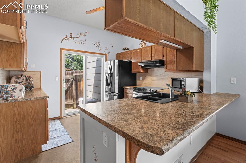 Image 6 of 26: Kitchen has walk-out to a courtyard area