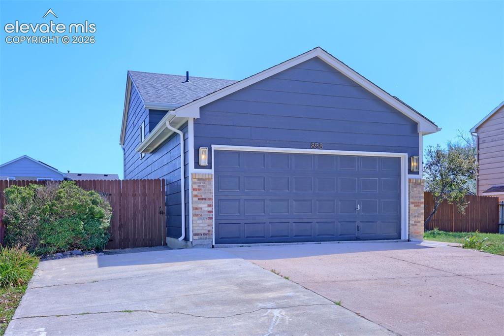 Image 35 of 35: Two-story exterior featuring blue siding and brick accents
