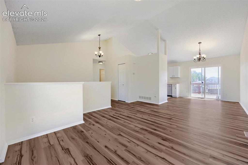Image 6 of 35: Vaulted ceilings complement the wood-finish flooring