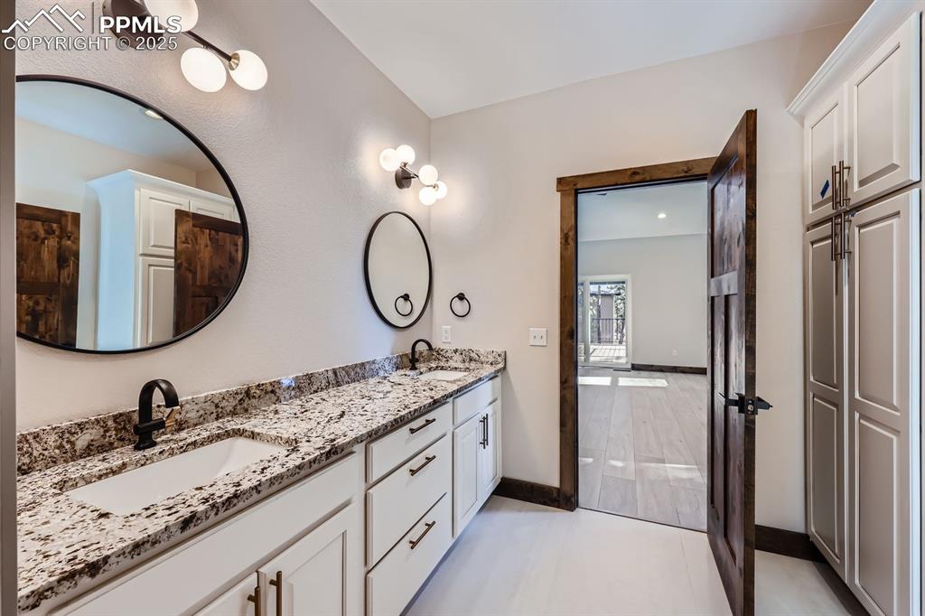 Image 18 of 33: Home is completed with a mixture of matte black and gold fixtures.