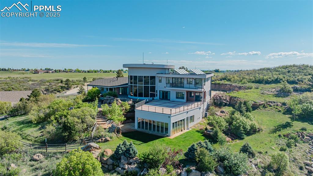 Image 42 of 42: Back of property featuring a sunroom, a balcony, and stairway