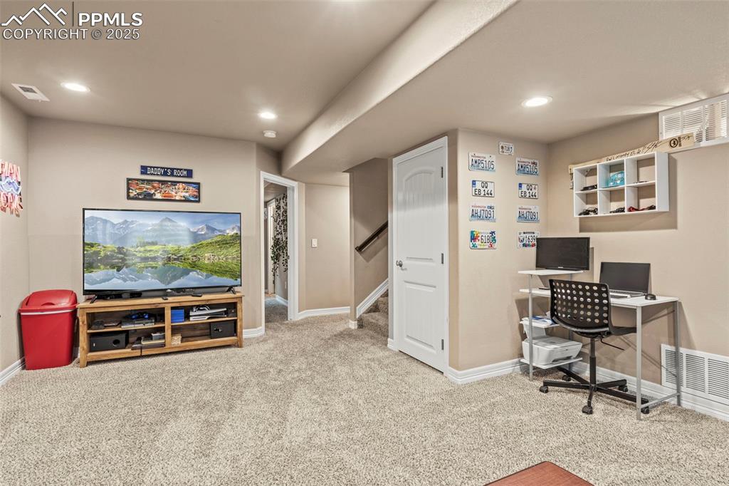Image 29 of 48: Carpeted home office featuring baseboards, visible vents, and recessed ligh